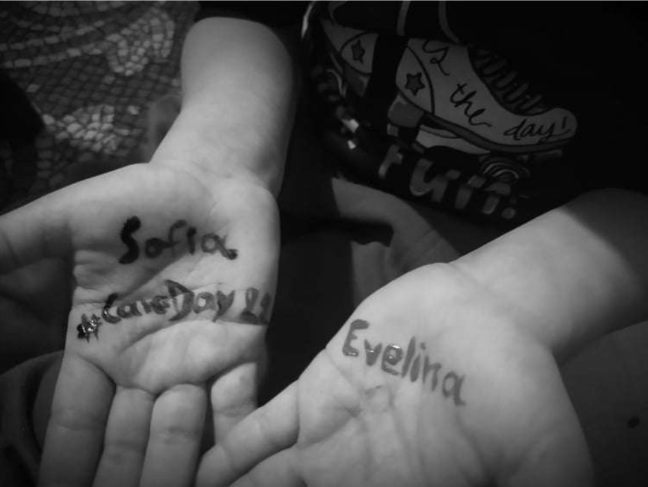 Hands with the hashtags #CareDay22 and #CareAware written on it