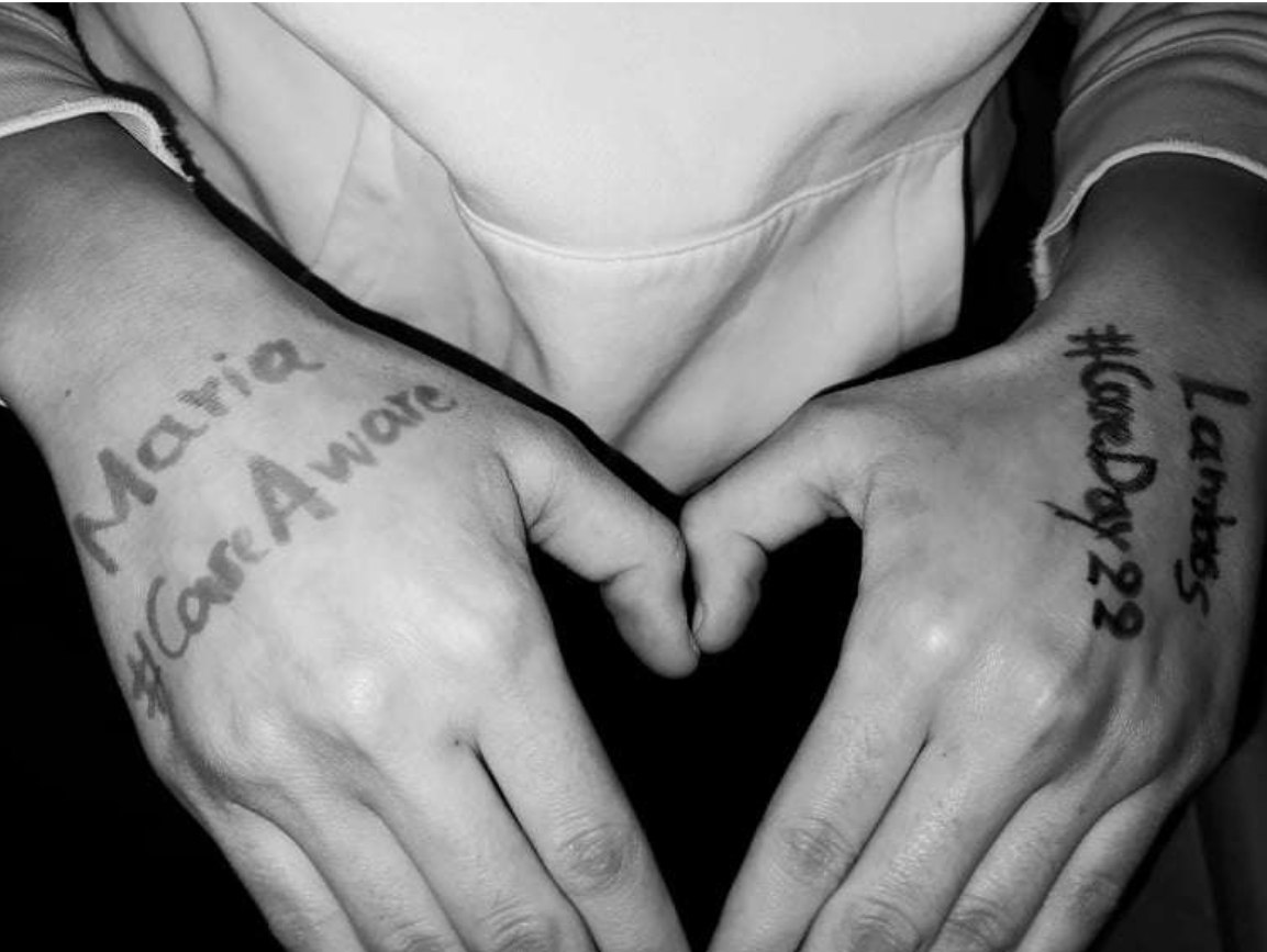 Hands with the hashtags #CareDay22 and #CareAware written on it