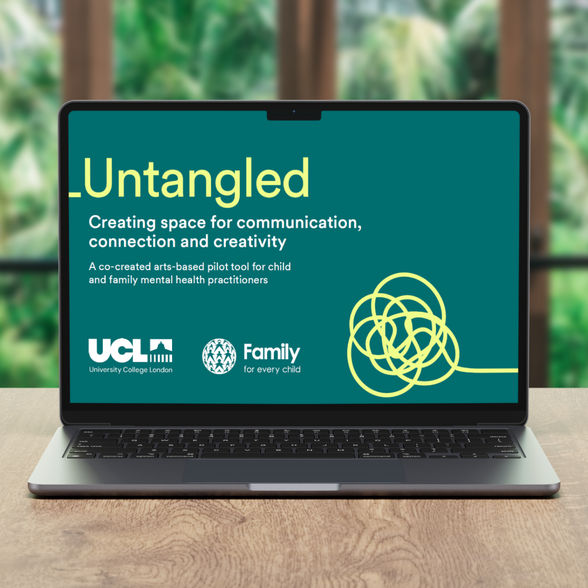 Front page of Untangled on a computer screen with window in the background, with fuzzy greenery seen behind the window.